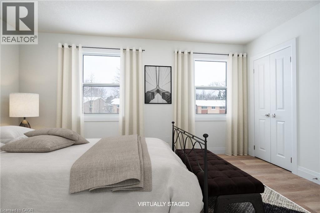 Bedroom featuring wood finished floors and a closet