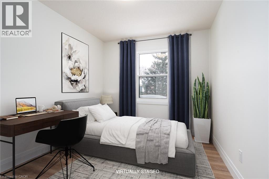 Bedroom featuring baseboards and wood finished floors