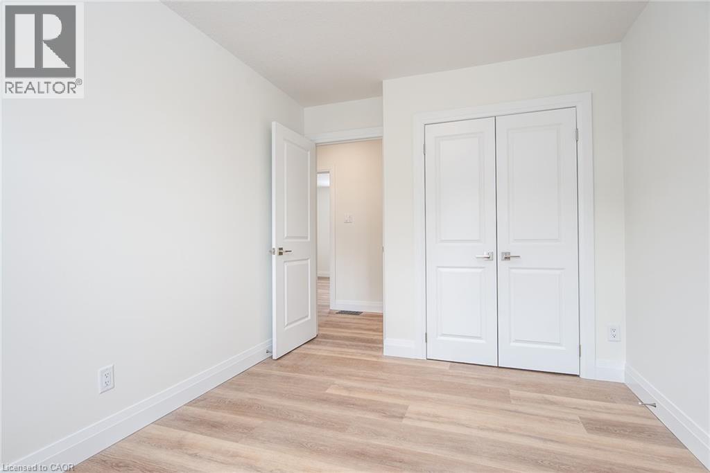 Unfurnished bedroom with light wood-style floors and a closet