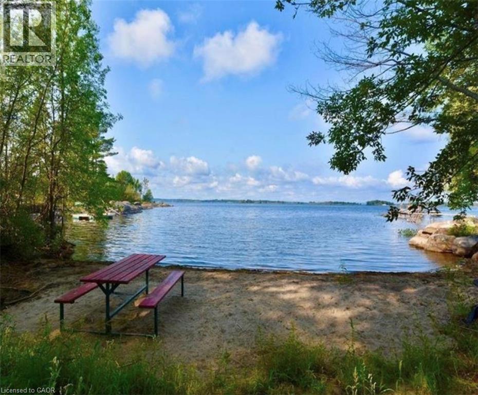 The property features a sandy beach area with direct access to the water