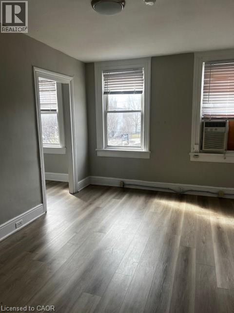 This room features light-colored walls, durable flooring, and two windows equipped with blinds