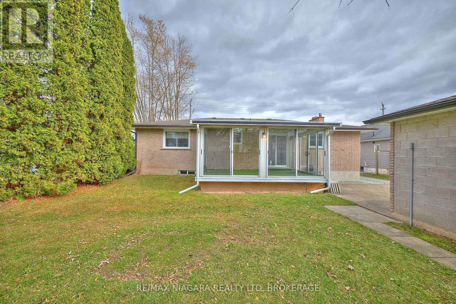 Back of home with sunroom
