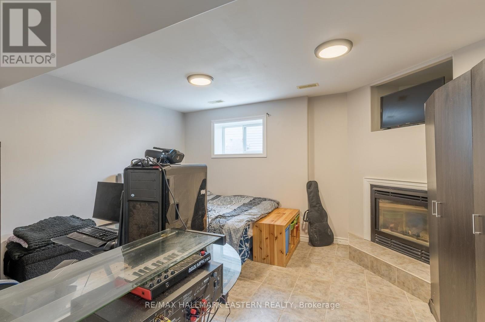 Lower bedroom with cozy gas fireplace