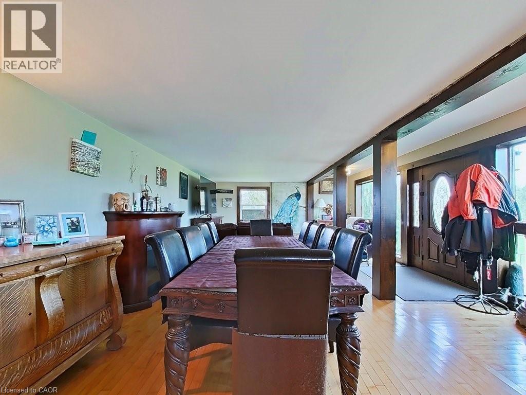 The property features wood flooring throughout this spacious area, complemented by exposed wooden beams
