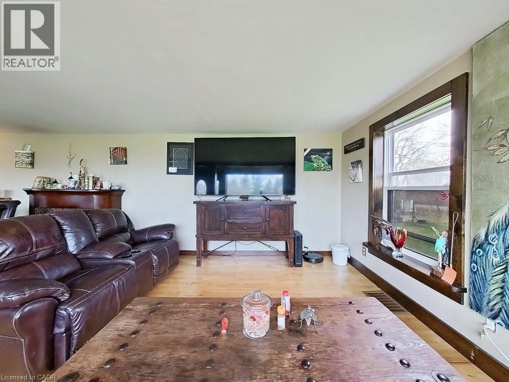 Living area featuring light-colored walls and wood flooring