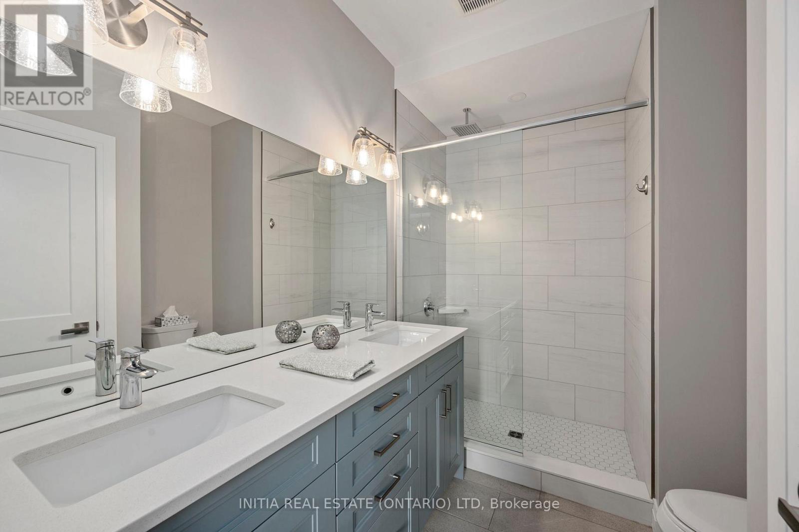 Ensuite with double sinks and walk in glass shower