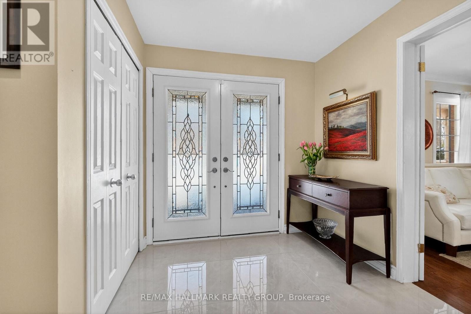 Double door entry to Italian porcelain tiled foyer
