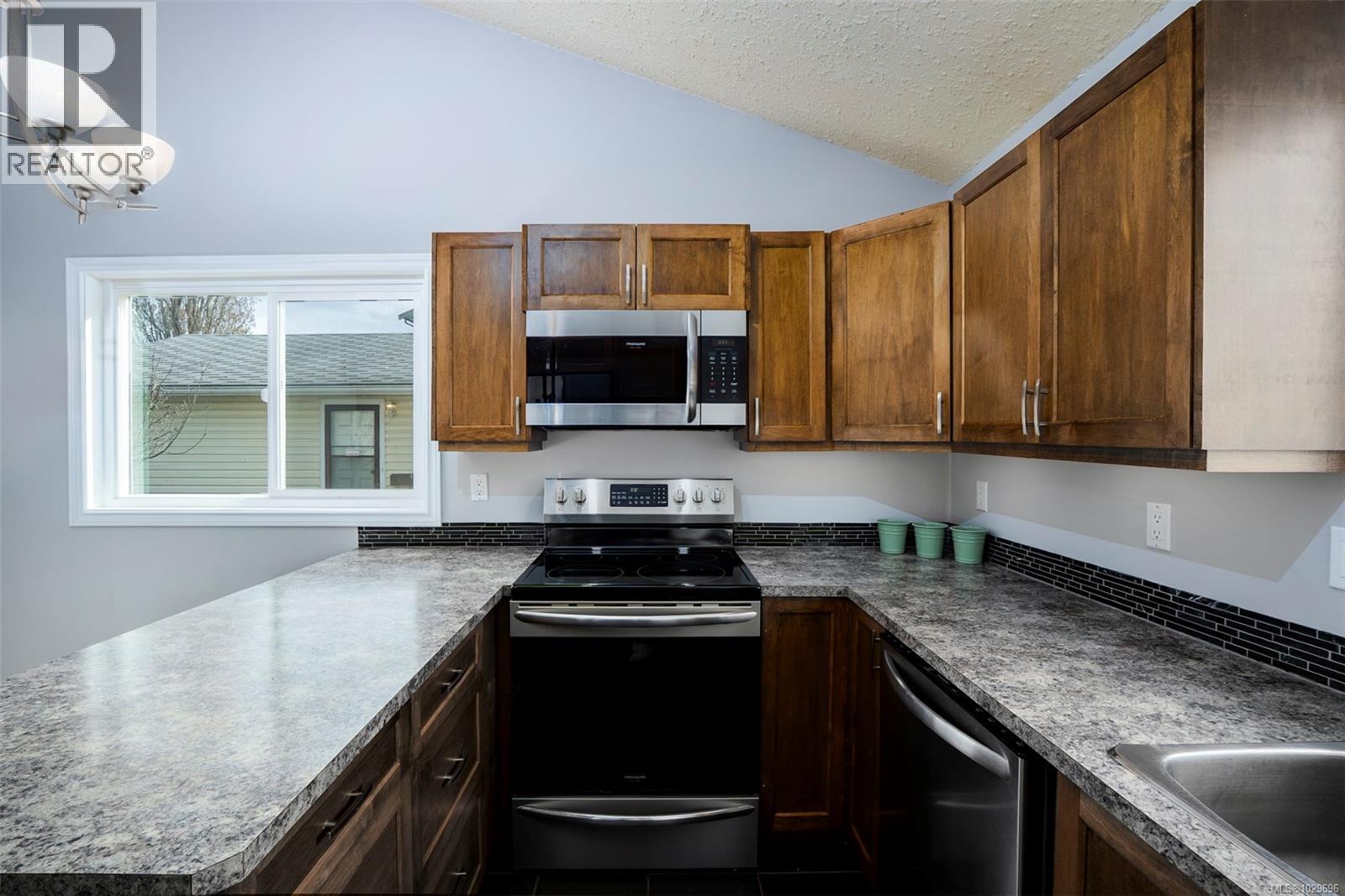 Stainless steel appliances including rangehood microwave and dishwasher