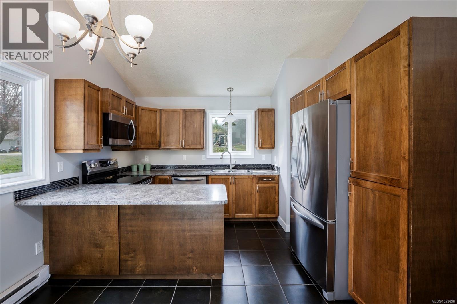 Updated kitchen with stainless appliances, tile floors