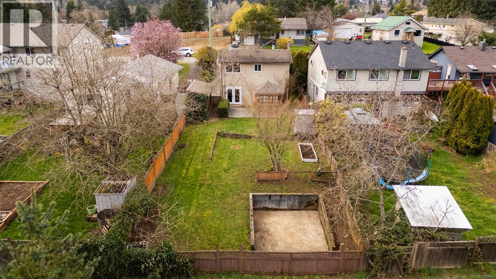 A birds eye view to a very usable (fenced) yard with room for gardensand even ''roughed in'' for a future garage or shop at the lane.