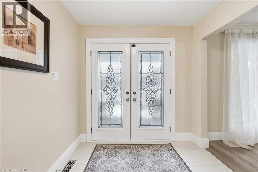 Doorway featuring french doors and baseboards