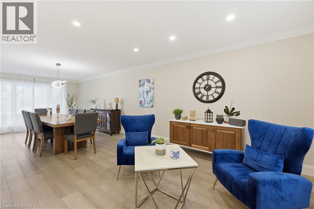 Living area featuring crown molding, light wood-style floors, and recessed lighting