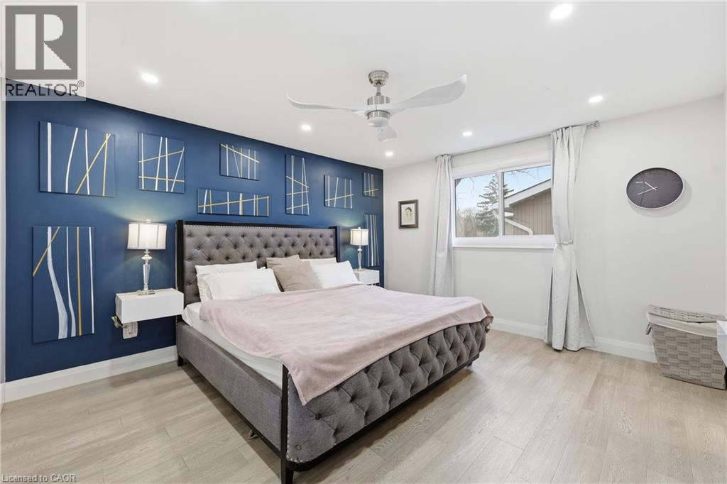 Bedroom featuring a ceiling fan, light wood-type flooring, and recessed lighting