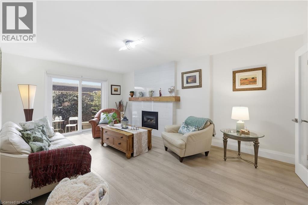 Living room featuring a glass covered fireplace and light wood finished floors