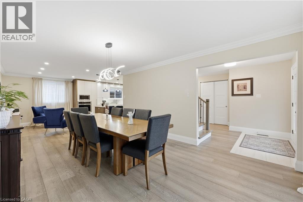 Dining area featuring ornamental molding, light wood finished floors, and a chandelier