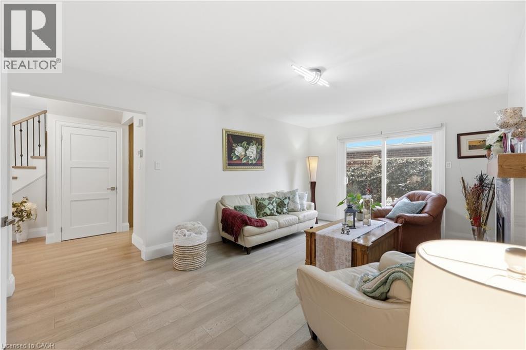 Living area with light wood finished floors and baseboards