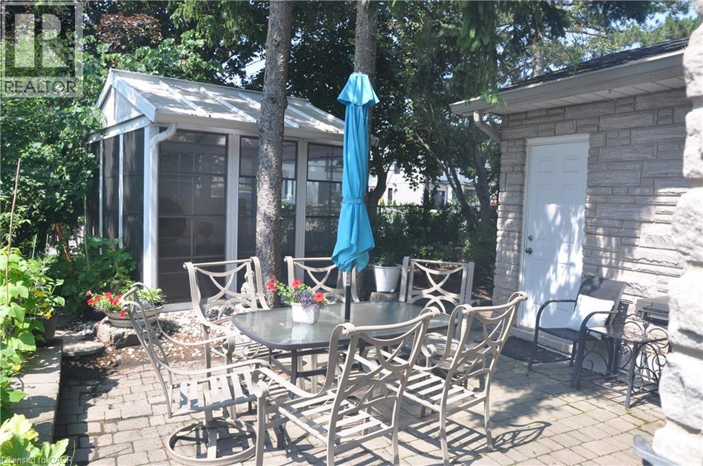 View of patio featuring outdoor dining space and a sunroom