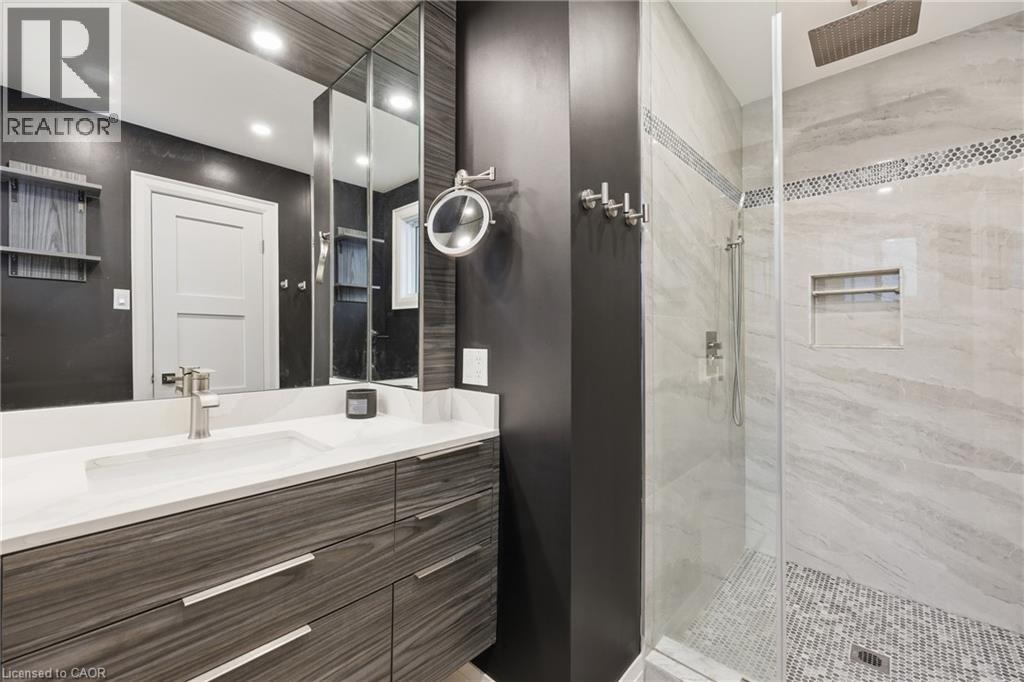 Bathroom featuring vanity, a stall shower, and recessed lighting