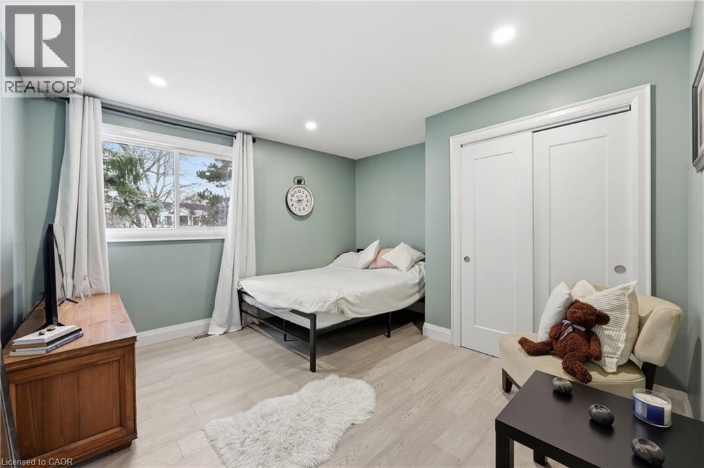 Bedroom with light wood-style flooring, a closet, and recessed lighting
