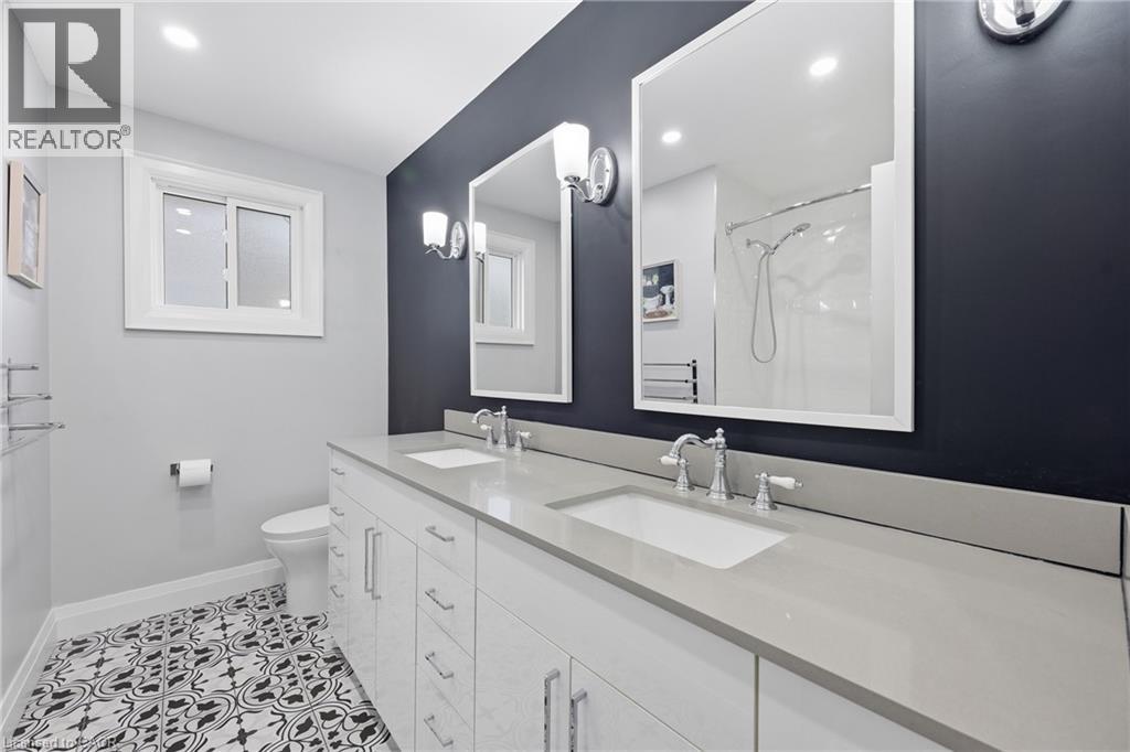 Bathroom featuring double vanity, a shower, light tile patterned floors, and recessed lighting