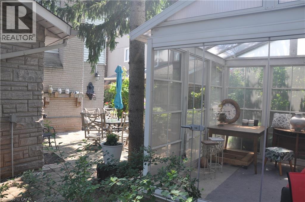 View of patio / terrace with a sunroom and outdoor dining space
