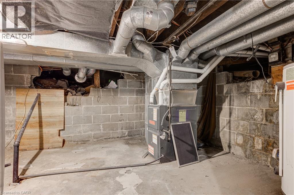 The property features a utility area with concrete block walls, exposed ductwork, and a hot water tank