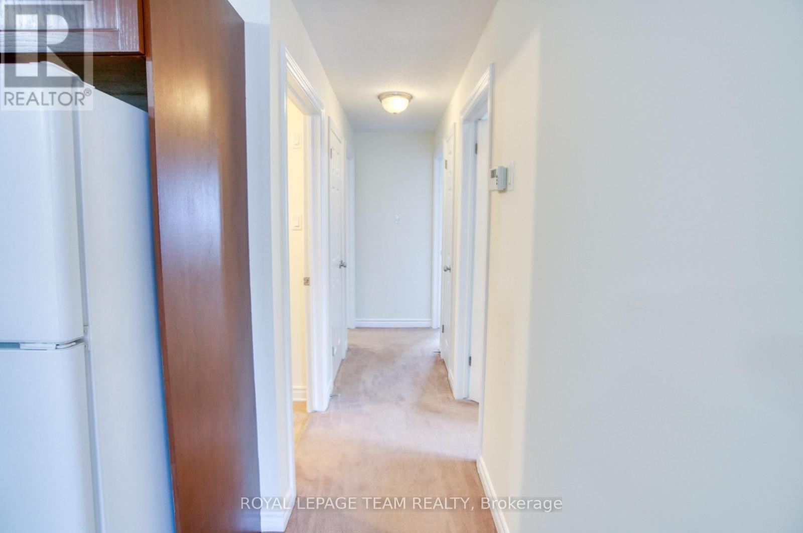 Hallway to bedrooms, full bath, and laundry