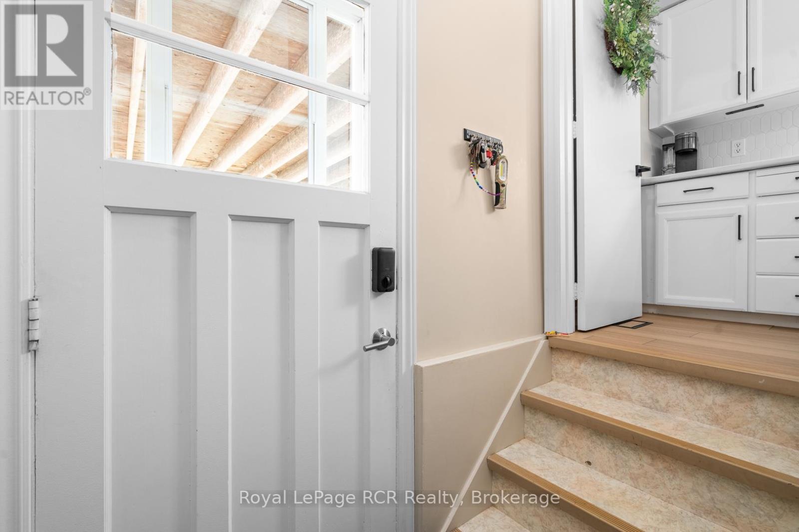 entry from carport and stairs to lower level