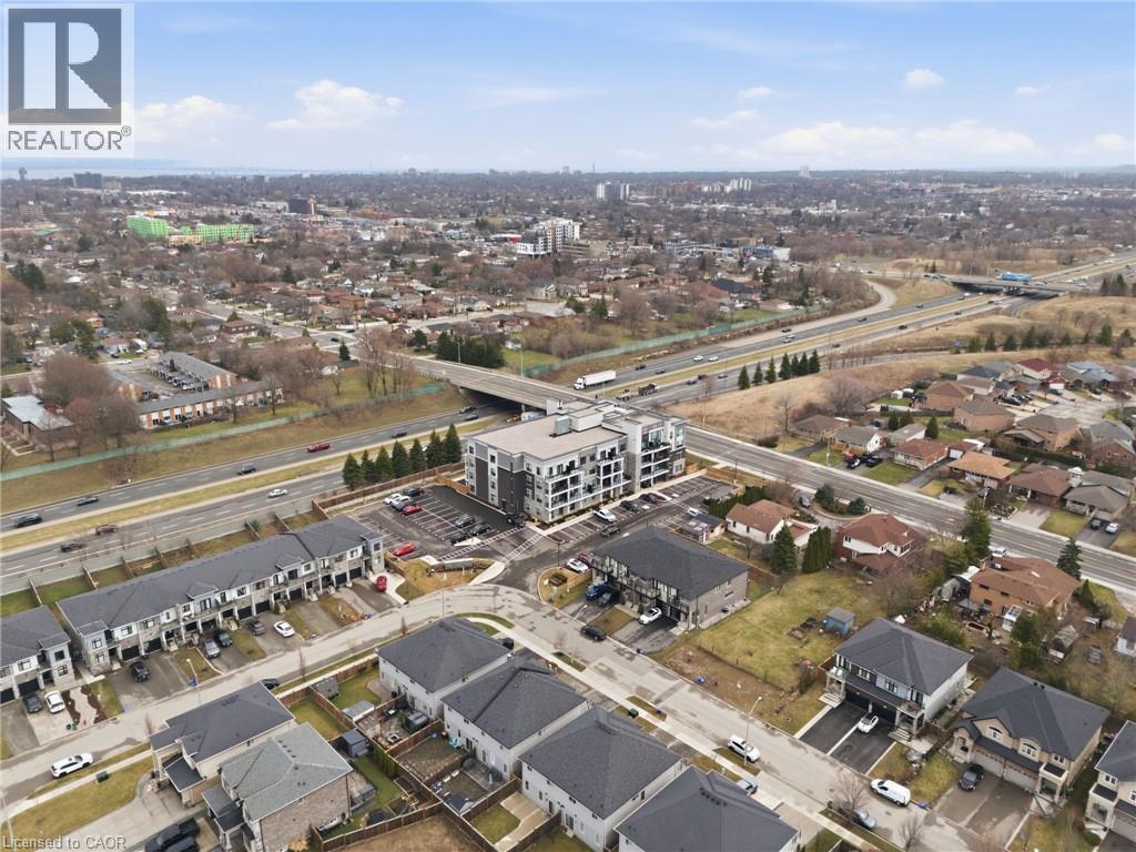 Aerial view of property's location featuring a main thoroughfare and nearby suburban area