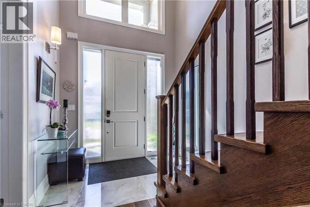 Entryway with healthy amount of natural light and dark marble finish flooring