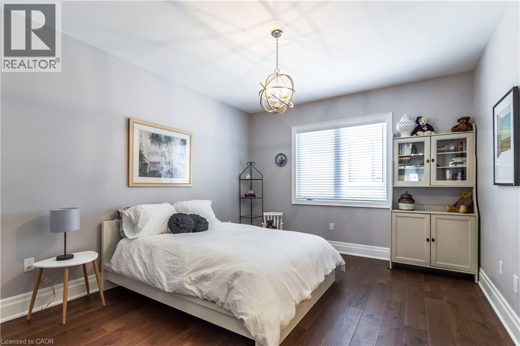 Bedroom featuring dark wood finished floors and hanging lights