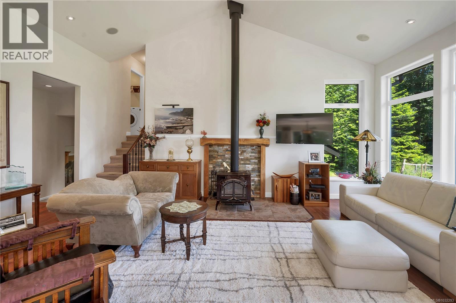the living room has a woodstove on brick hearth that keeps the home cozy