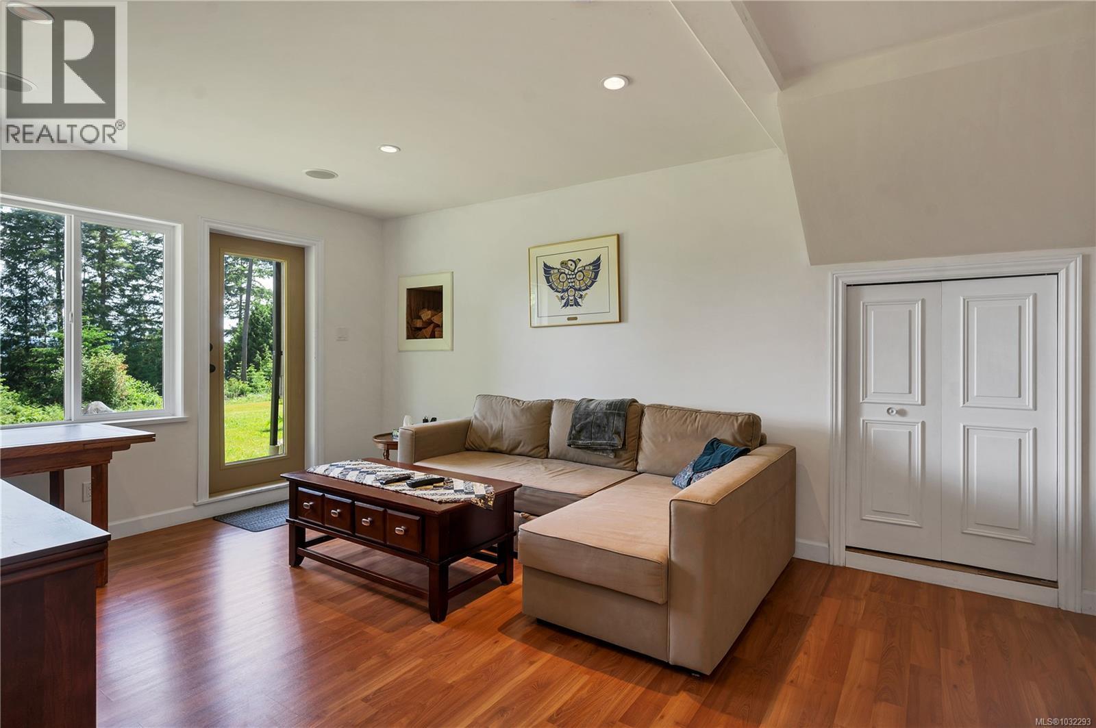 family room on lower floor, door to yard to left, the door to the right leads to the overheight crawl space