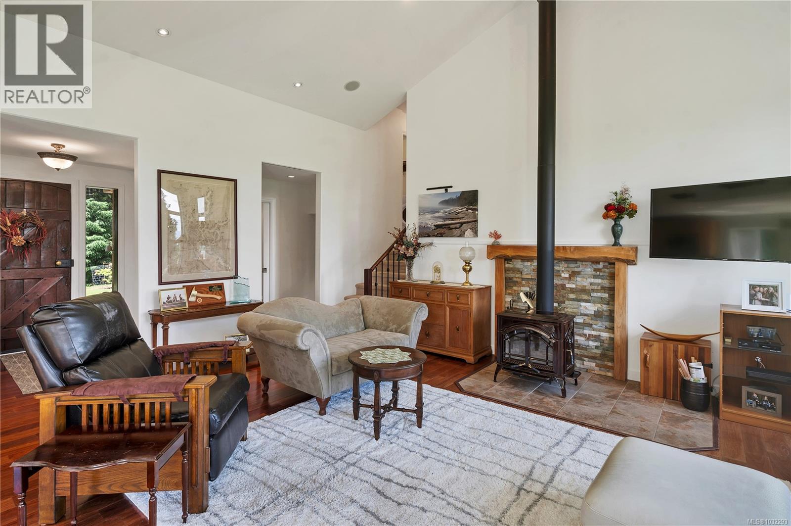 the entry opens to the living room with vaulted ceilings