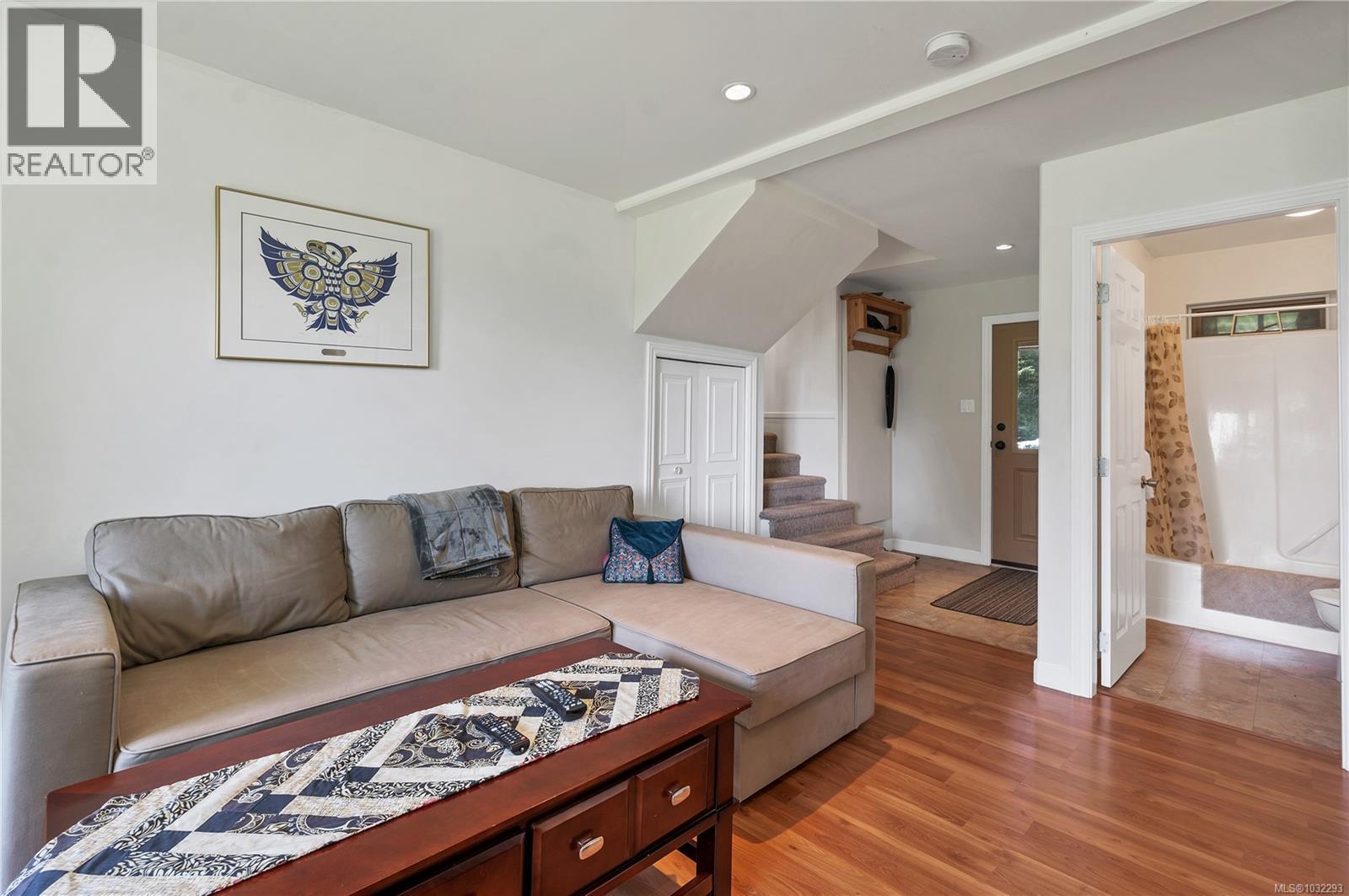 lower floor daylight basement family room, door in the middle of photo leads to mudroom/storage room, door to right to 3pc bathroom