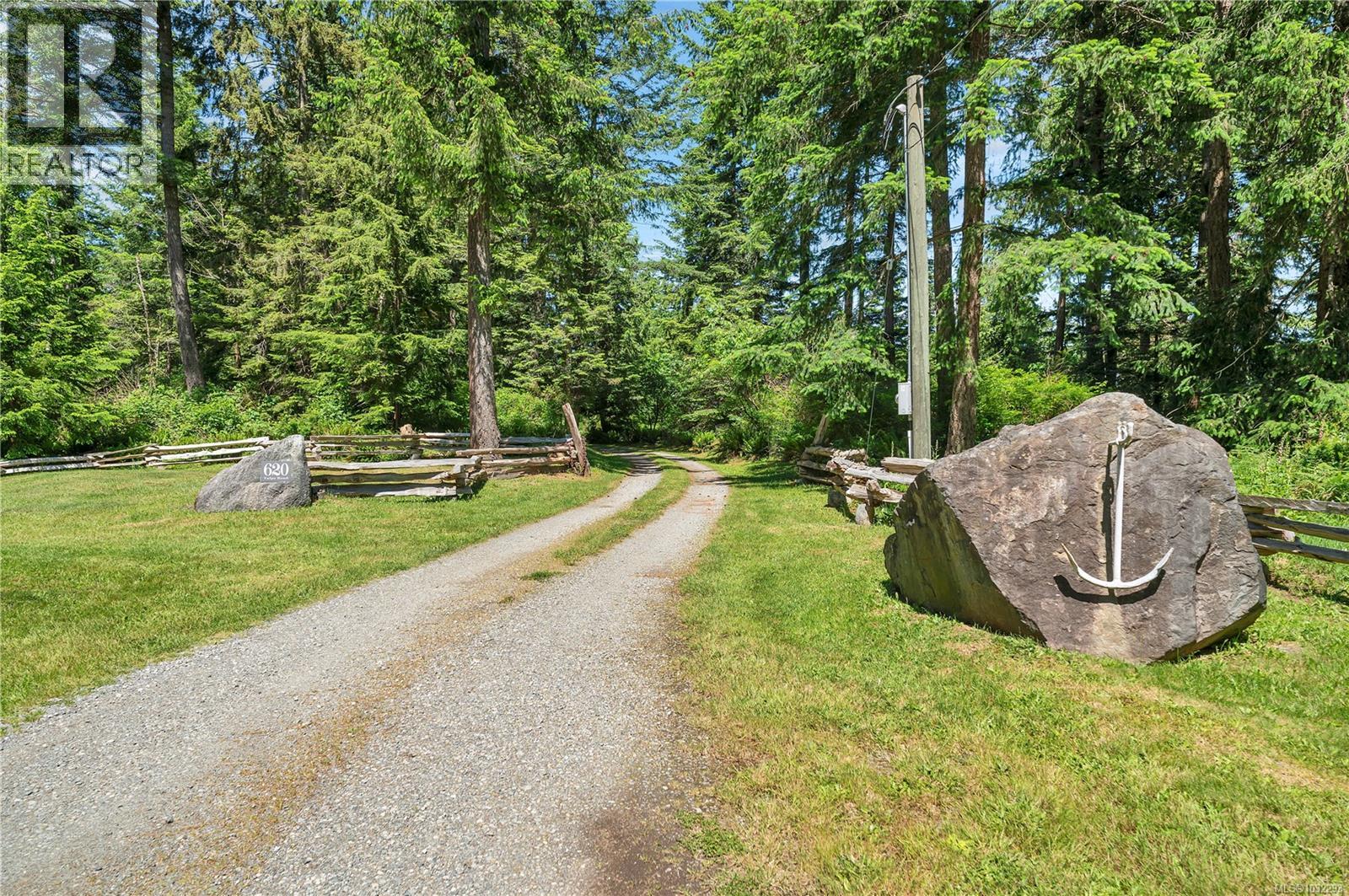 a gravel driveway leads to the shop & home