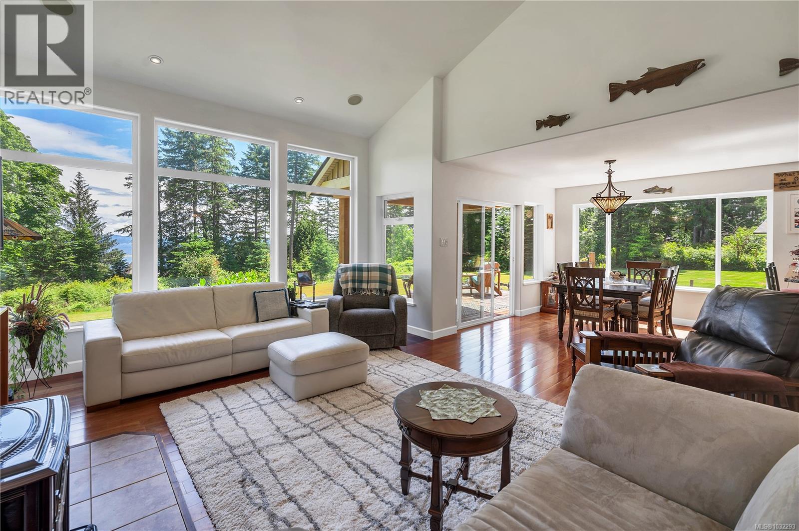 the living room opens to the dining room, large windows let in plenty of natural light
