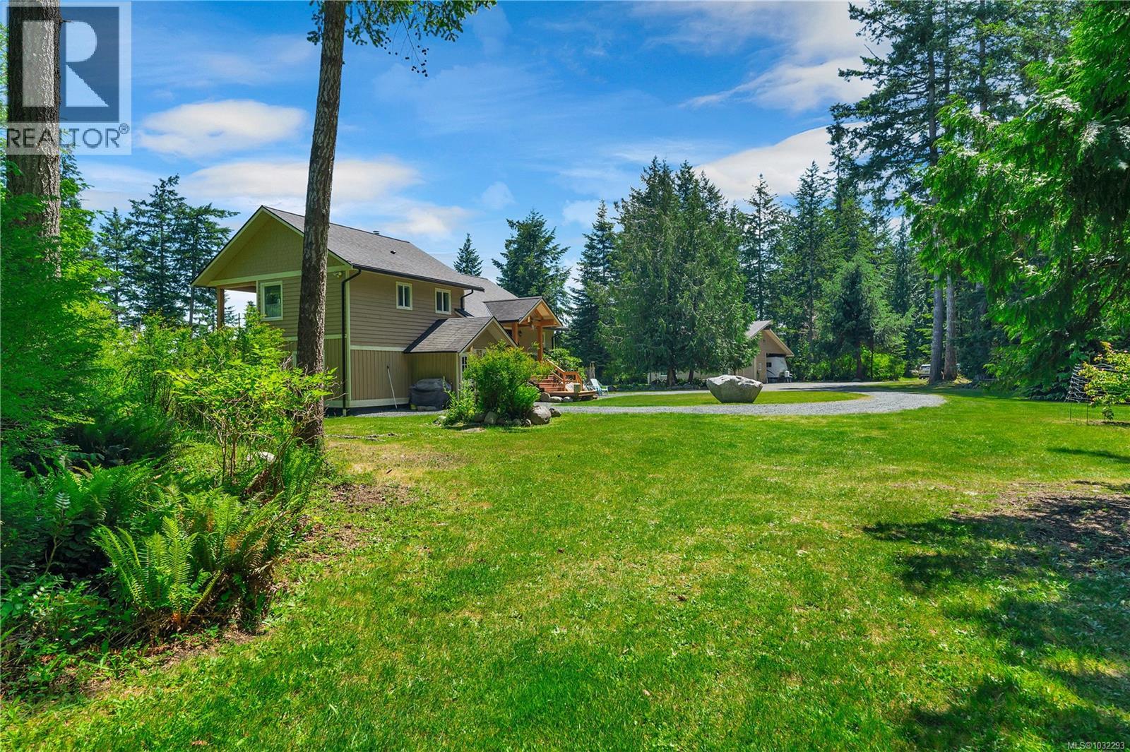 beautifully landscaped acreage, view from back/west side of home