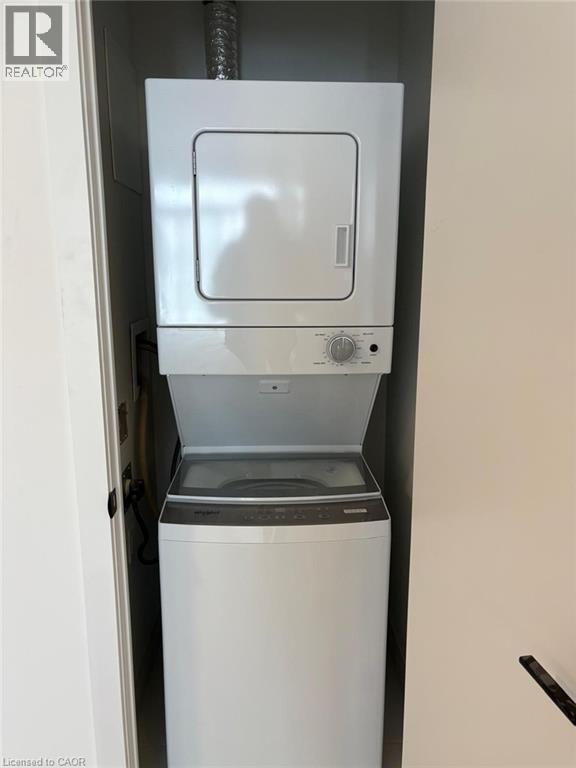 The property features a stacked white washer and dryer unit, conveniently located within a dedicated closet space