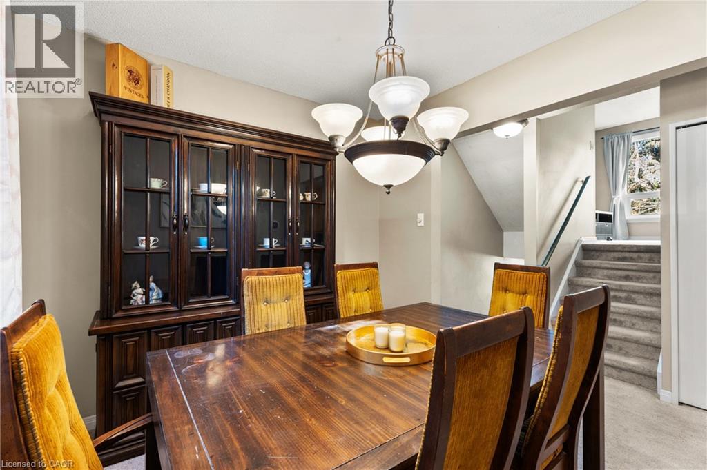 The property features a dining area with neutral wall tones and a chandelier