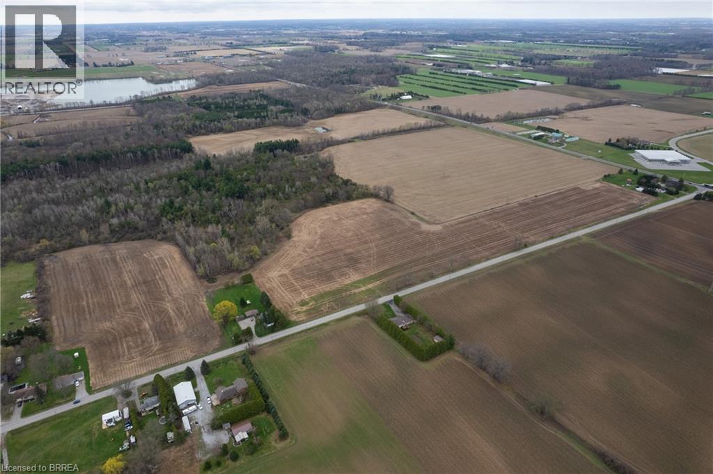 Aerial view showcasing extensive surrounding land and a visible road
