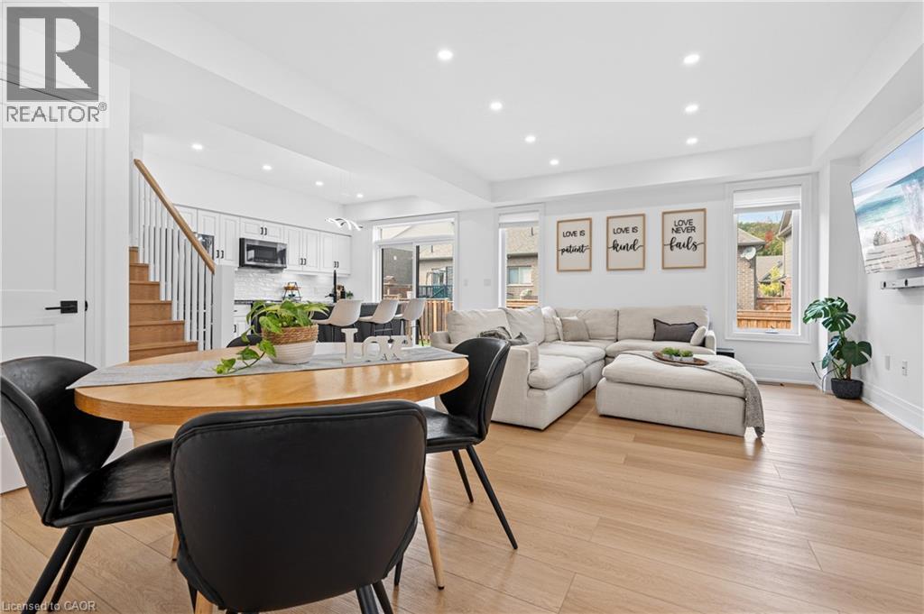 Bright open-concept living space with light wood-finish flooring