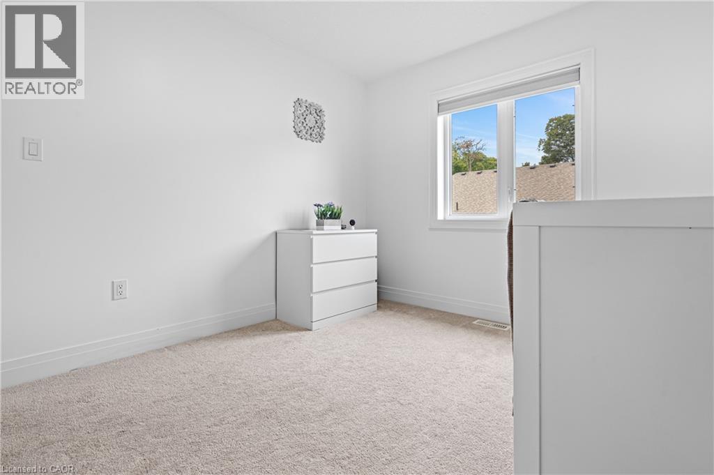 Bright interior space featuring a double-paned window, neutral wall paint, and light-toned carpeting