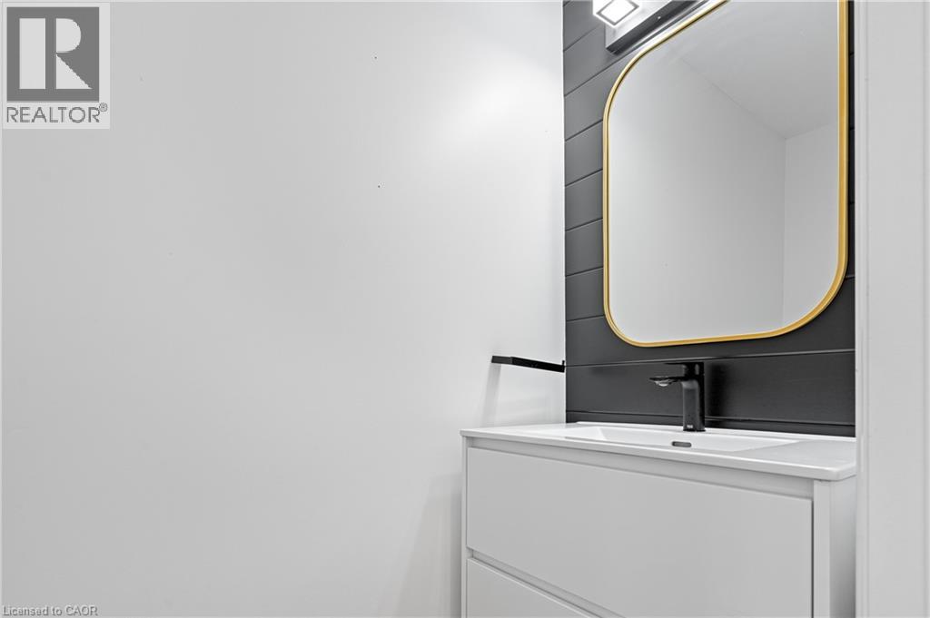 White floating vanity with integrated sink and matte black faucet