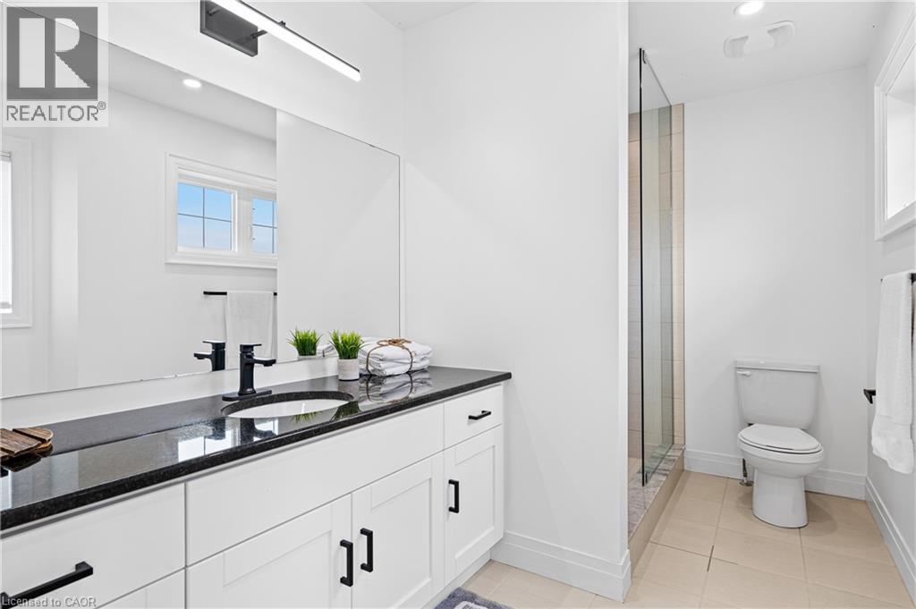 Double vanity with black countertop and undermount sinks