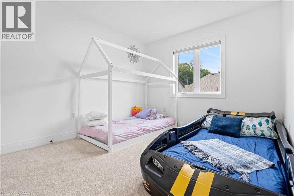 Room featuring light-colored carpet flooring and white painted walls