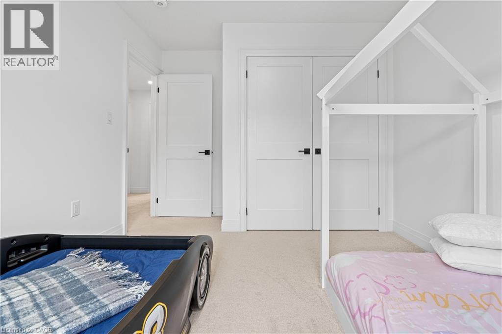 Bedroom featuring light-toned carpet flooring, white walls, and white trim