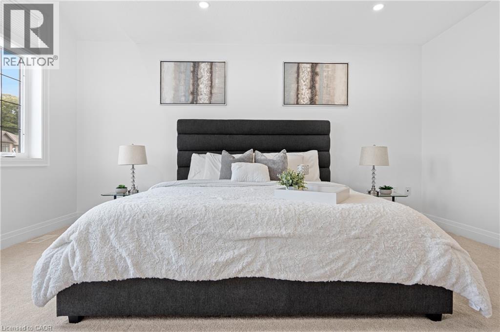 Spacious bedroom with light-toned carpet flooring and bright white walls