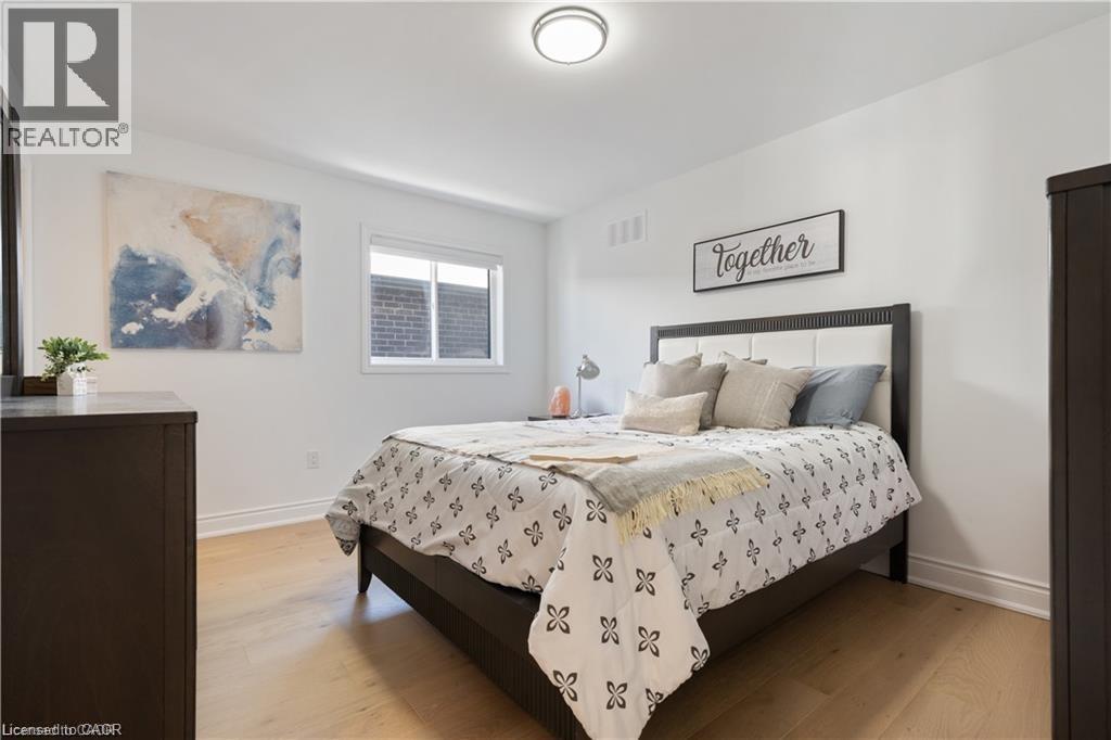 Bedroom with light wood-type flooring and baseboards