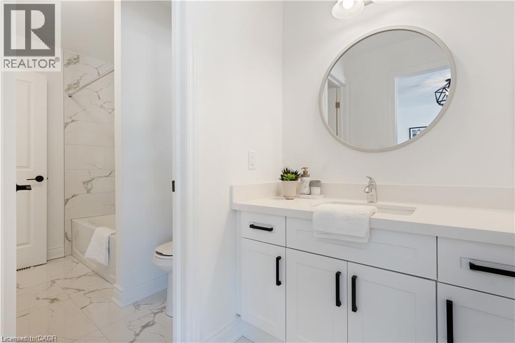 Bathroom with vanity and light marble finish flooring